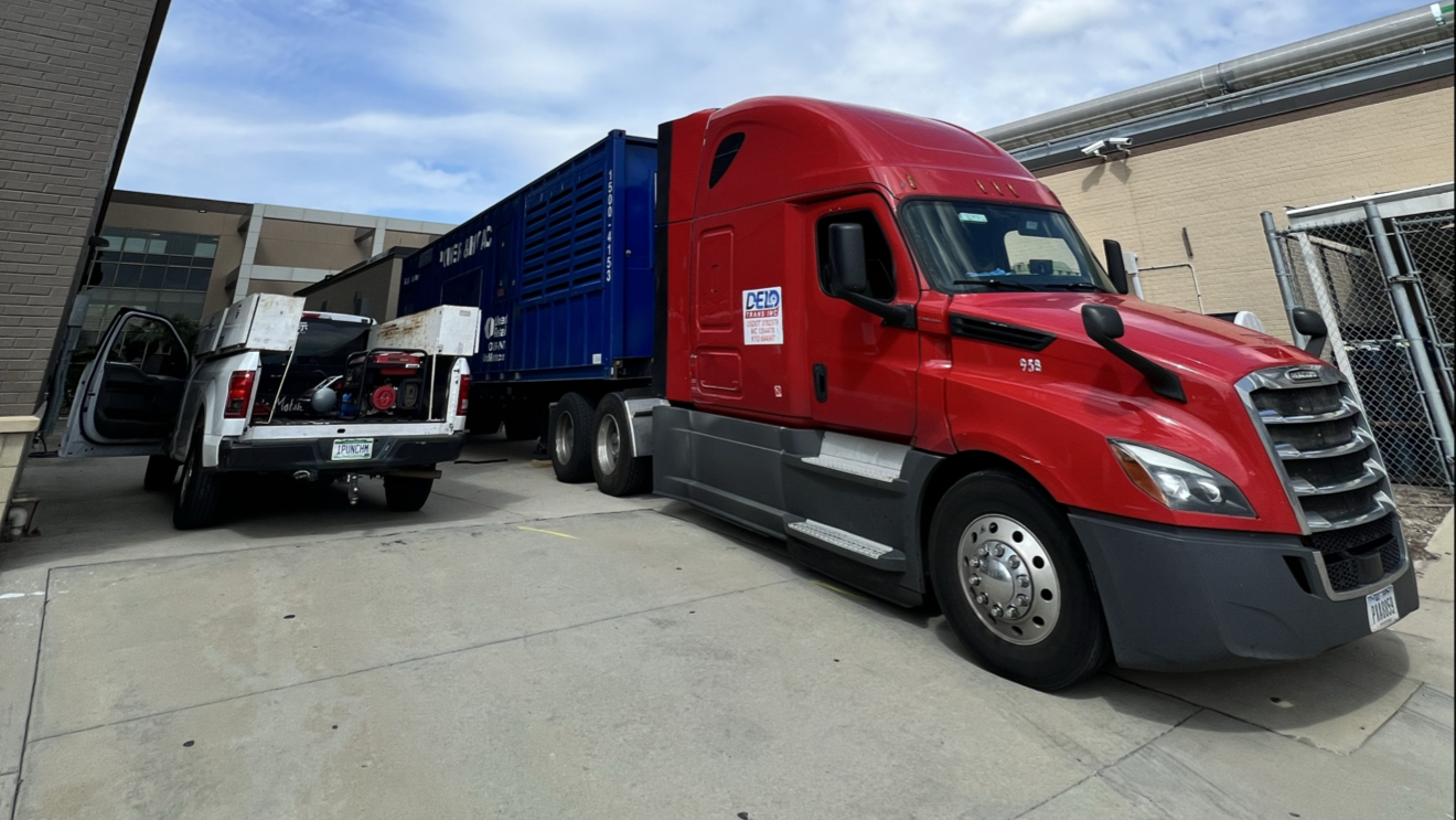 Red semi truck parked next to my work truck